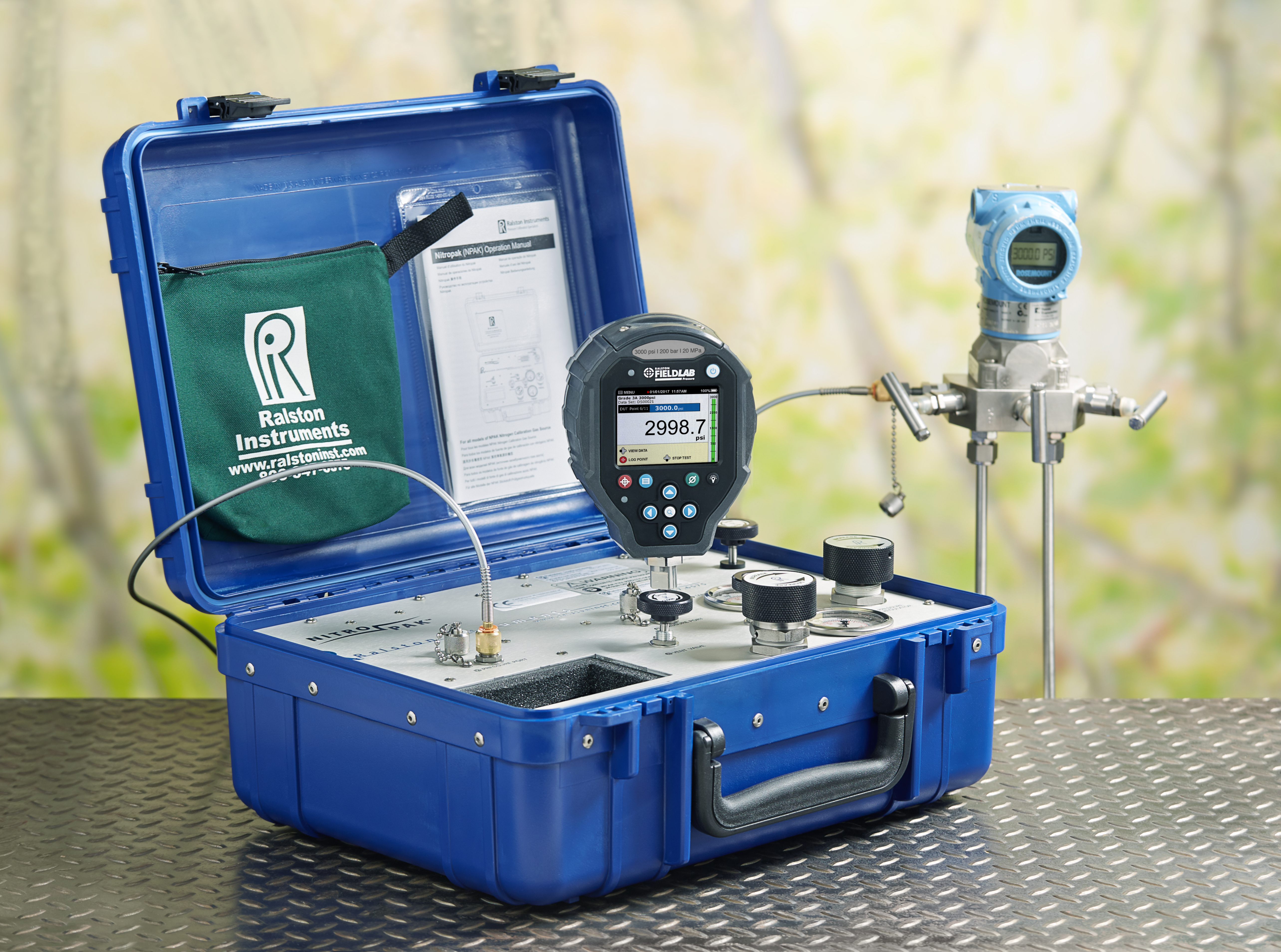 Ralston NitroPak Pressure Source with a FieldLab Pressure Calibrator connected during a field setup.