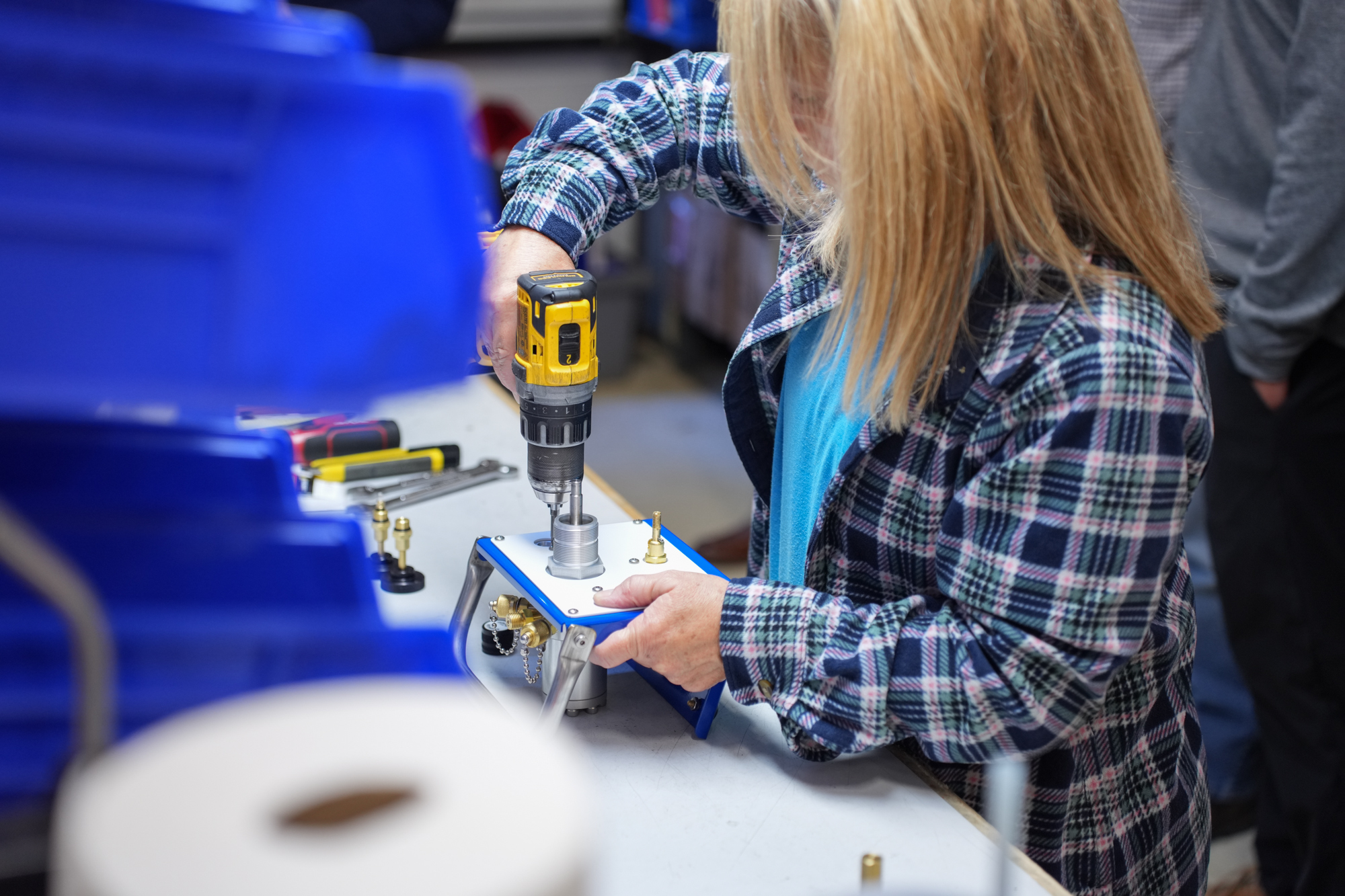Ralston Instruments employee assembling a compressed gas volume controller by hand in a production area