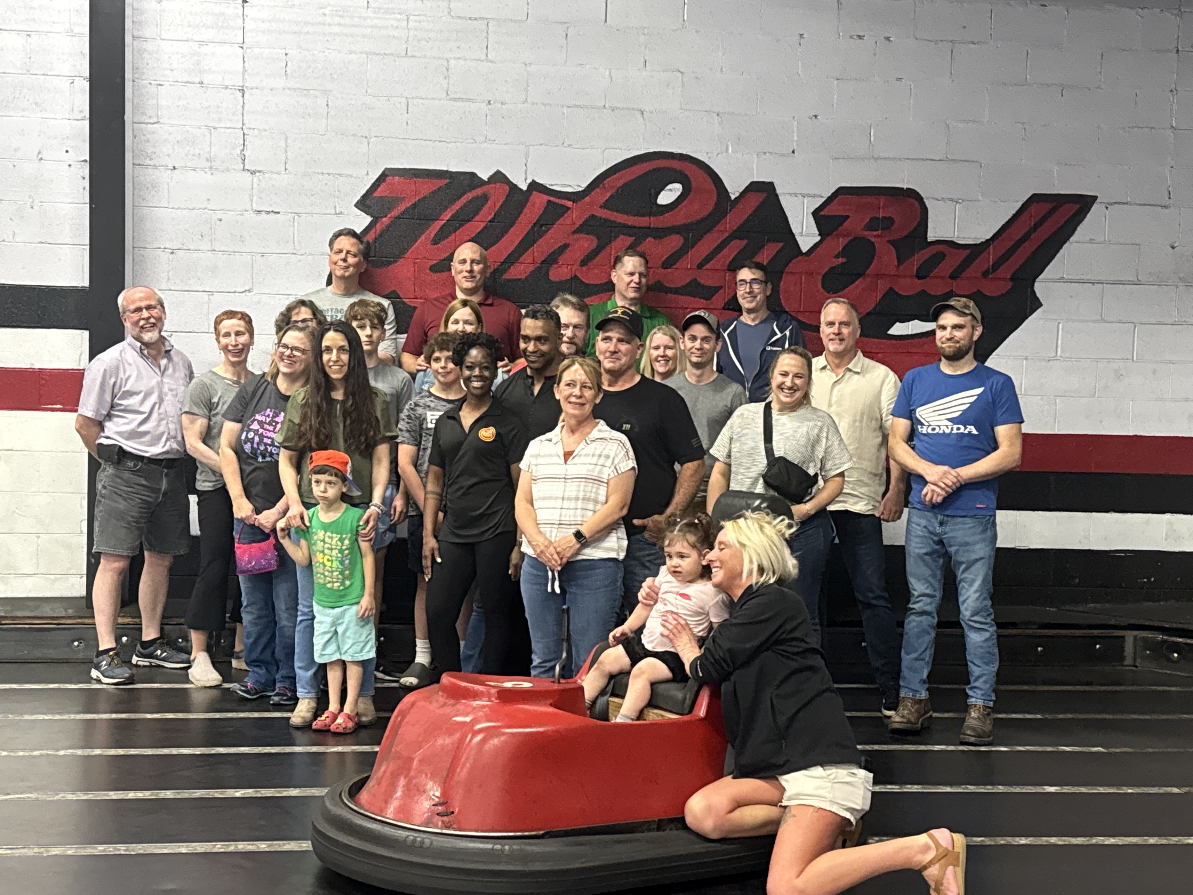 Ralston team members play WhirlyBall in bumper cars during an indoor team-building event.