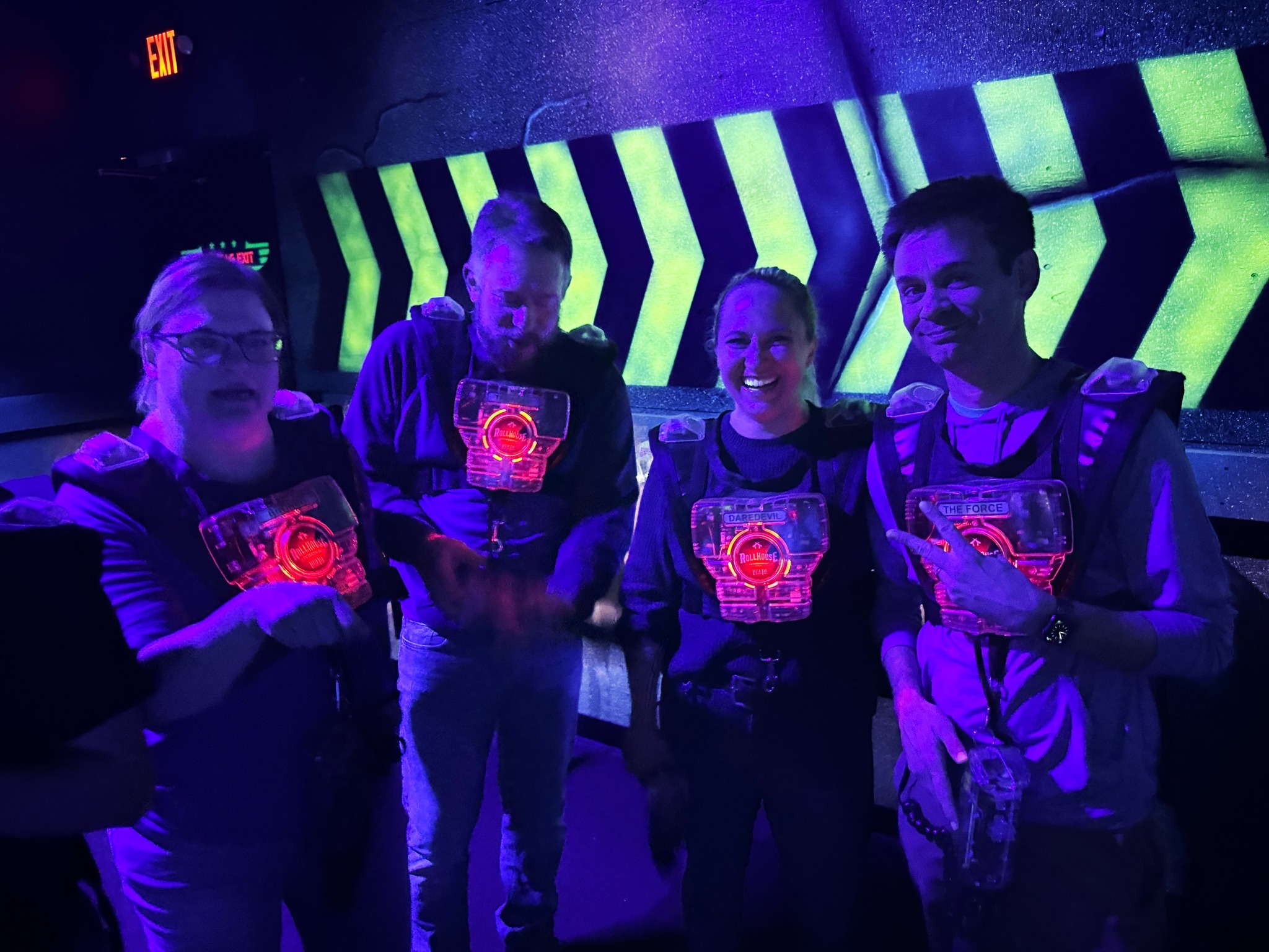 Ralston team members geared up in vests, smiling before the game begins.