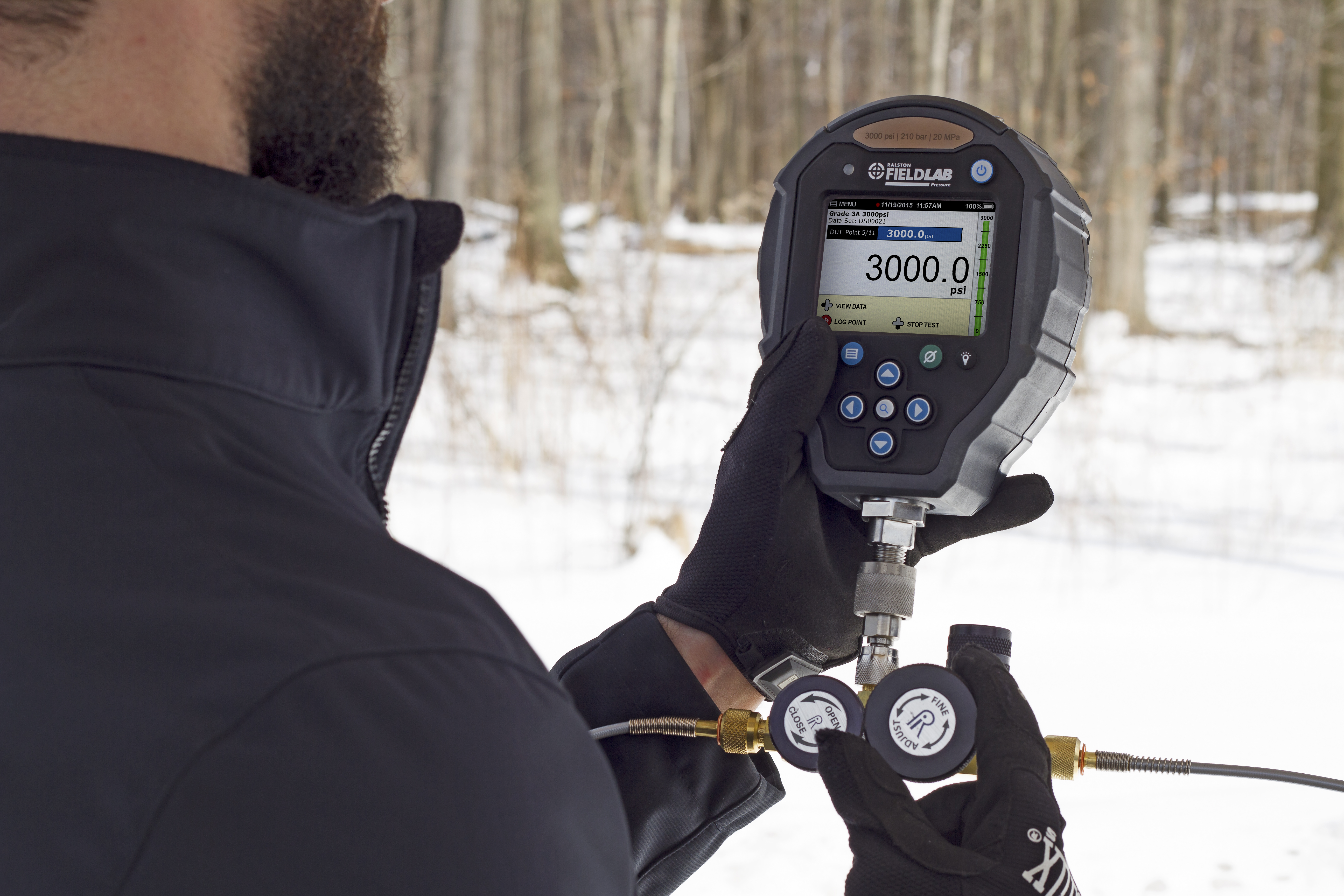 A technician working on industrial piping with a Ralston field gauge LC20