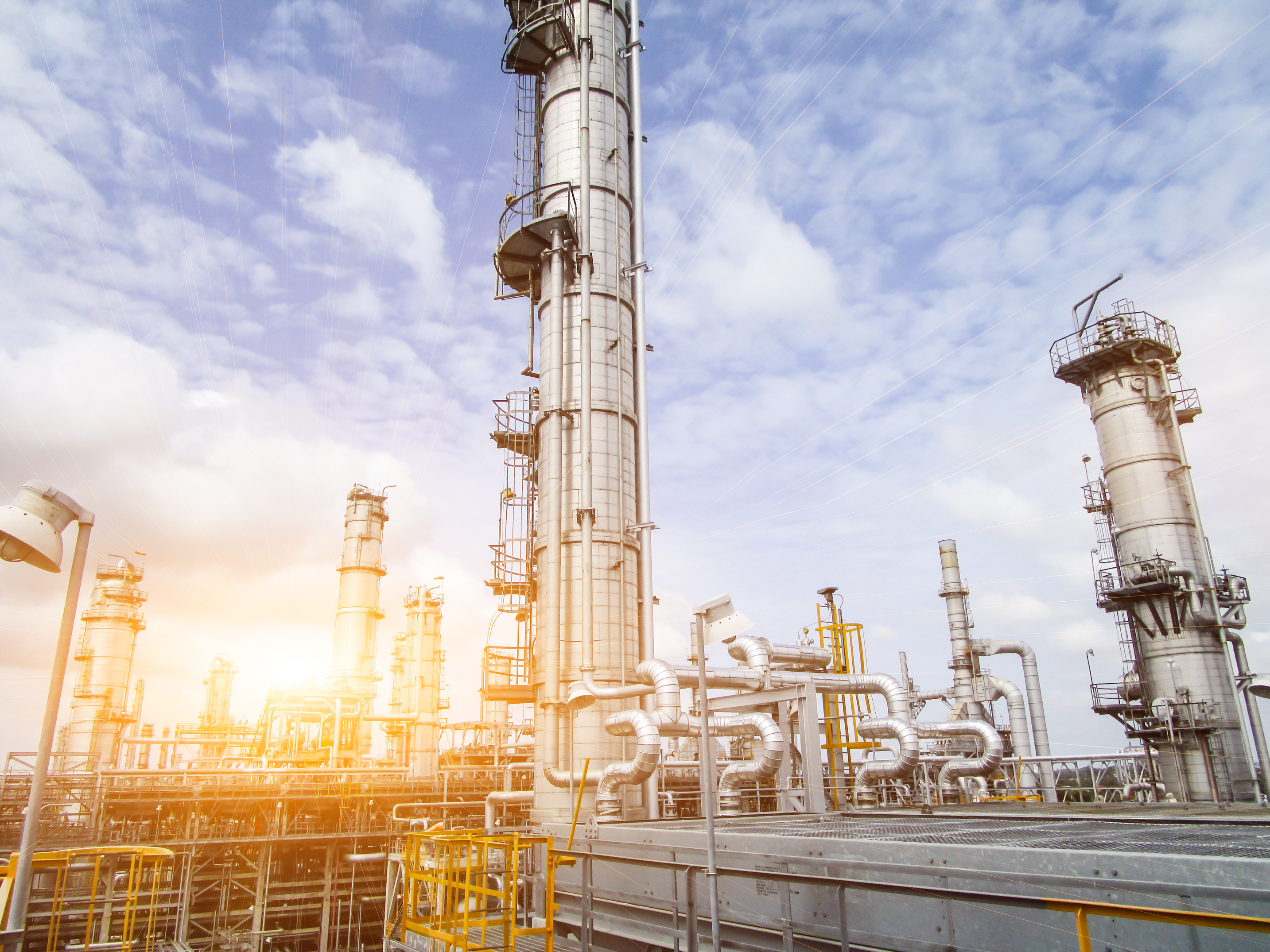 Industrial refinery with piping and process equipment, where pressure calibration and testing are performed