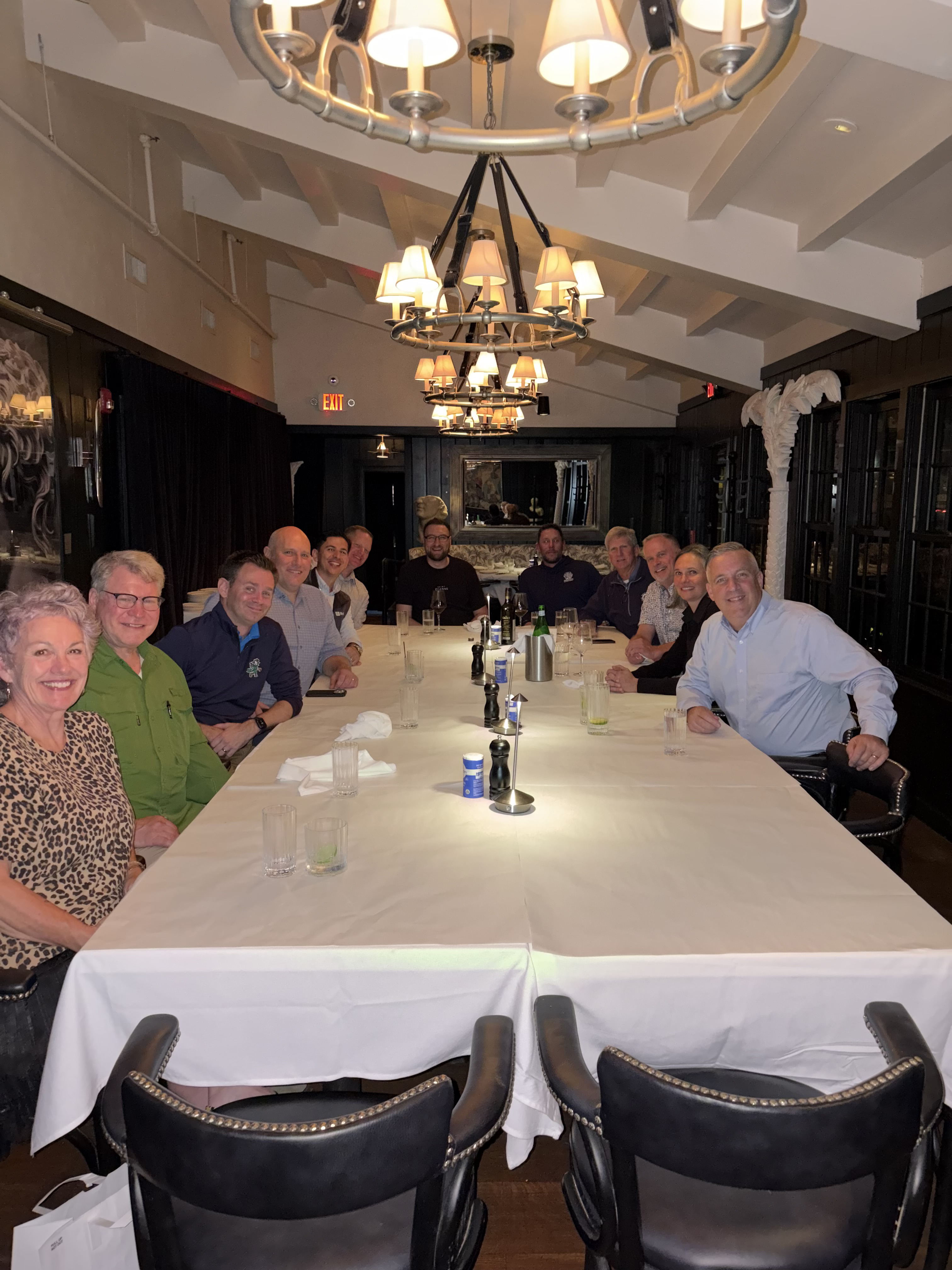 Ralston team members and distributors sit around a long dining table during an evening gathering in Cleveland, Ohio.