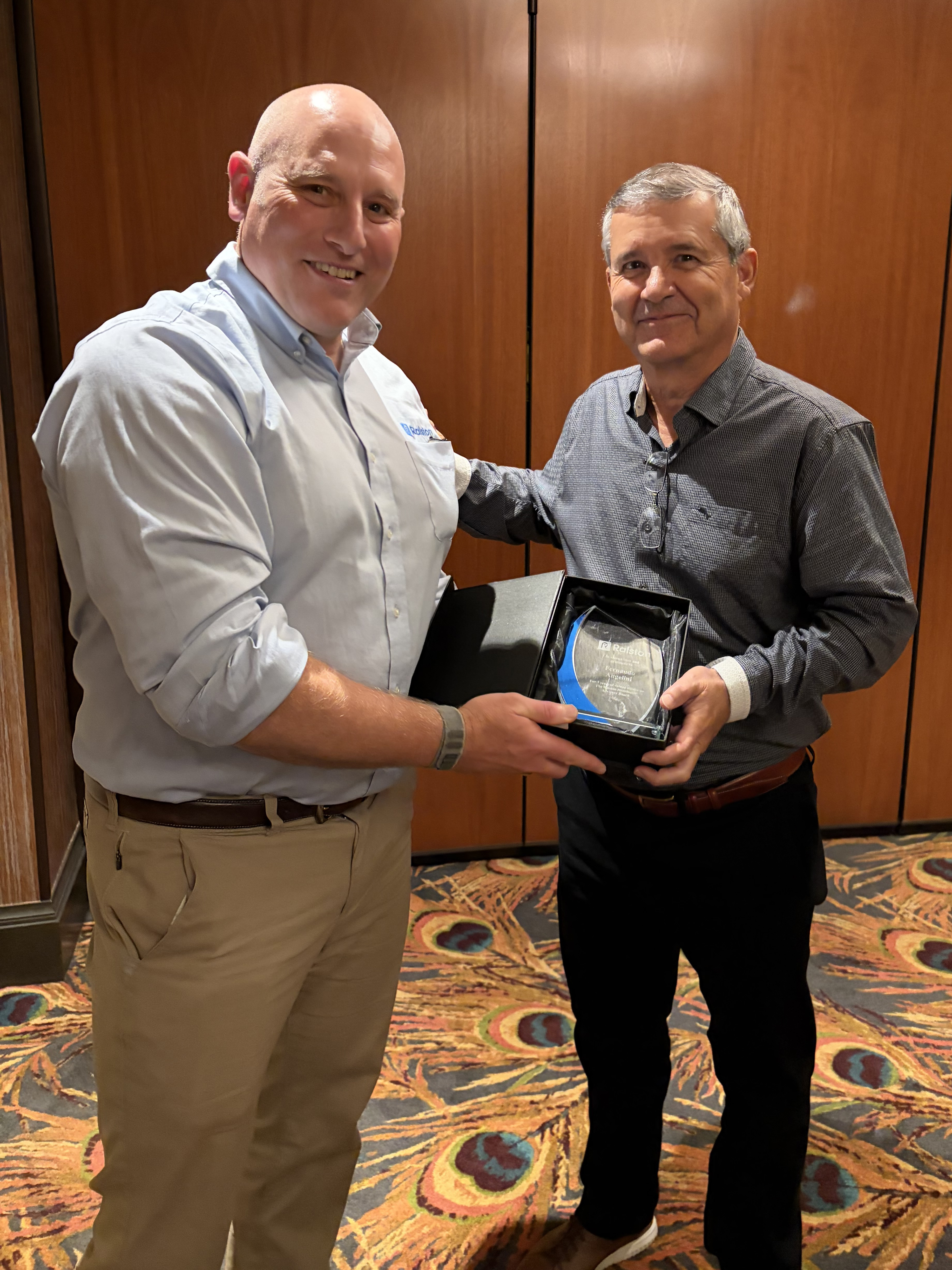 Griffin Ralston, CEO at Ralston (left), presents Fernando Angelini (right) with an award for 3 years of service on the DAB.