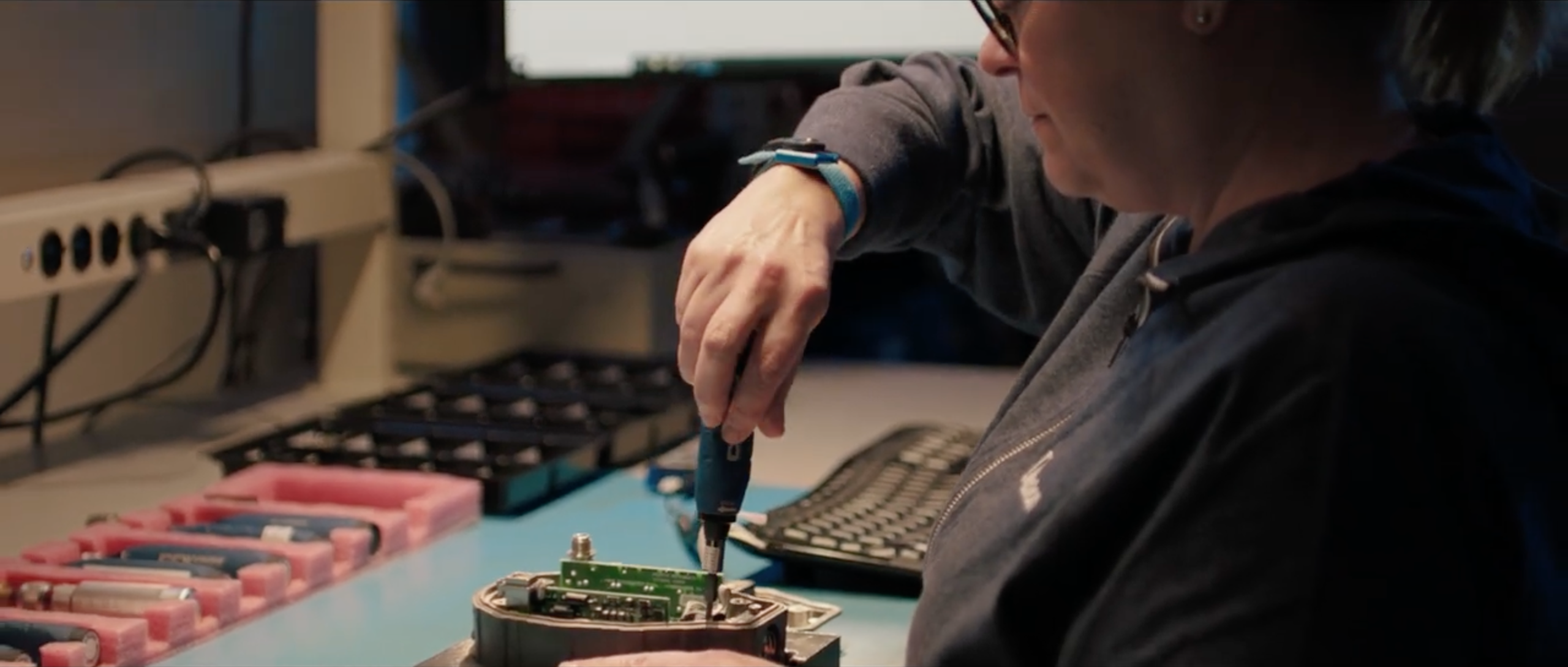 Ralston Instruments employee assembling pressure calibration equipment at a workstation.