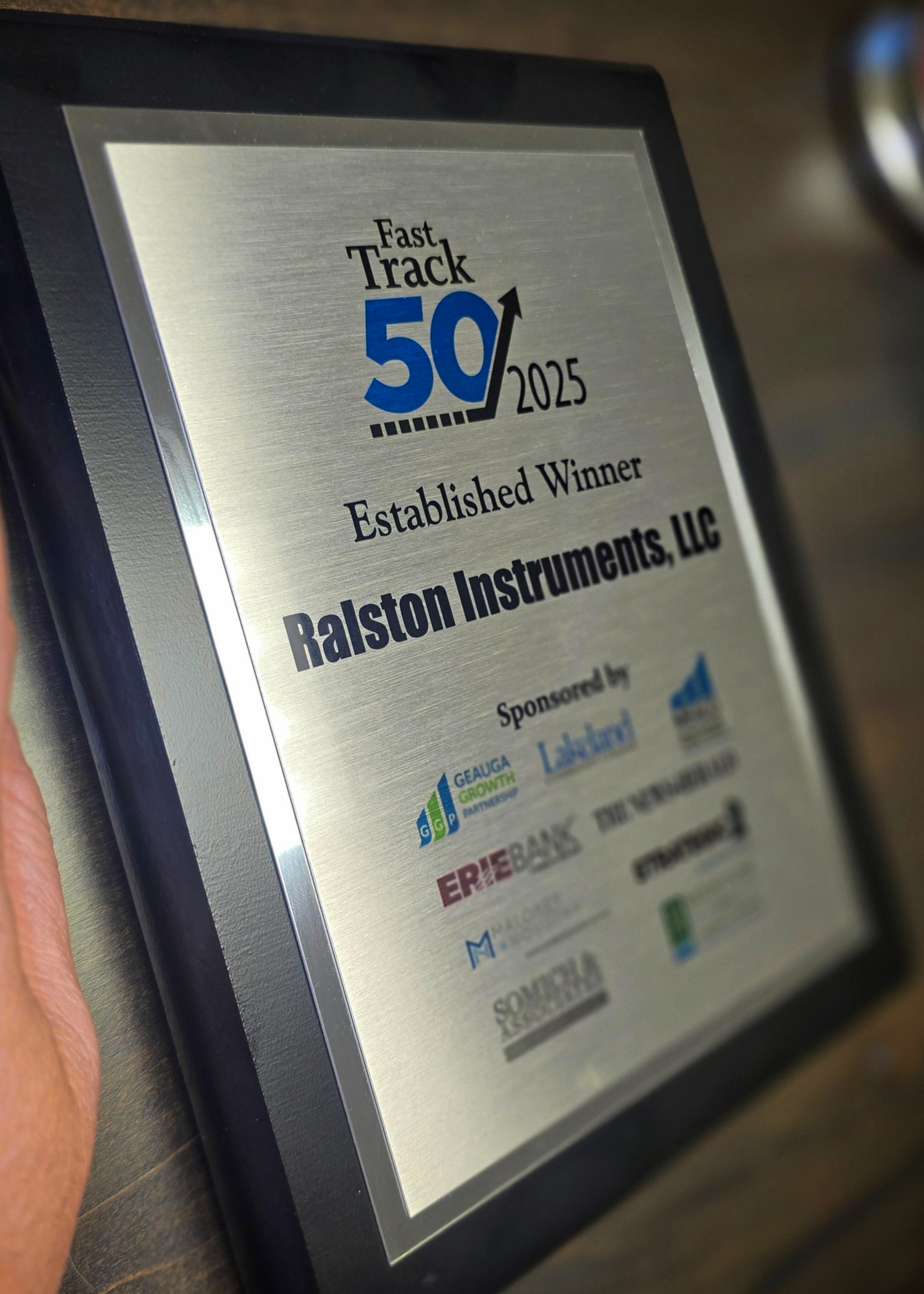 Close-up of the 2025 Fast Track 50 award plaque presented to Ralston Instruments.