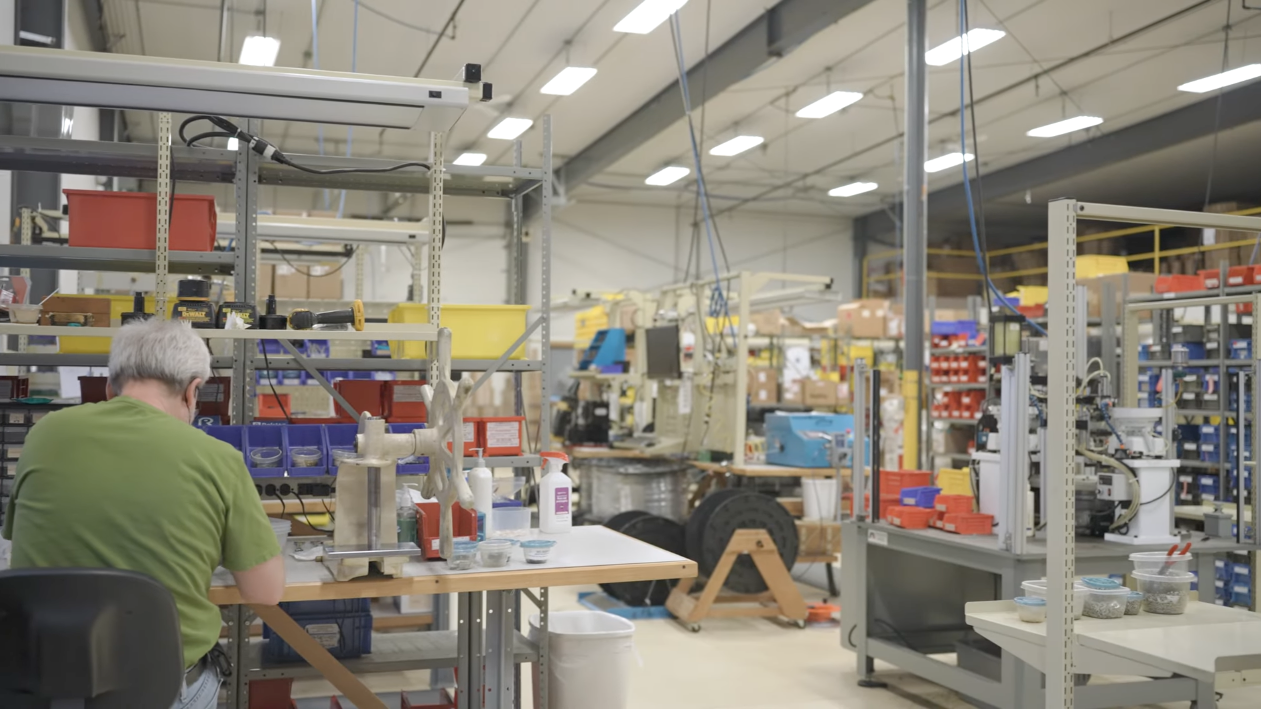 Technician working at an assembly workstation on the Ralston Instruments production floor with tools and components