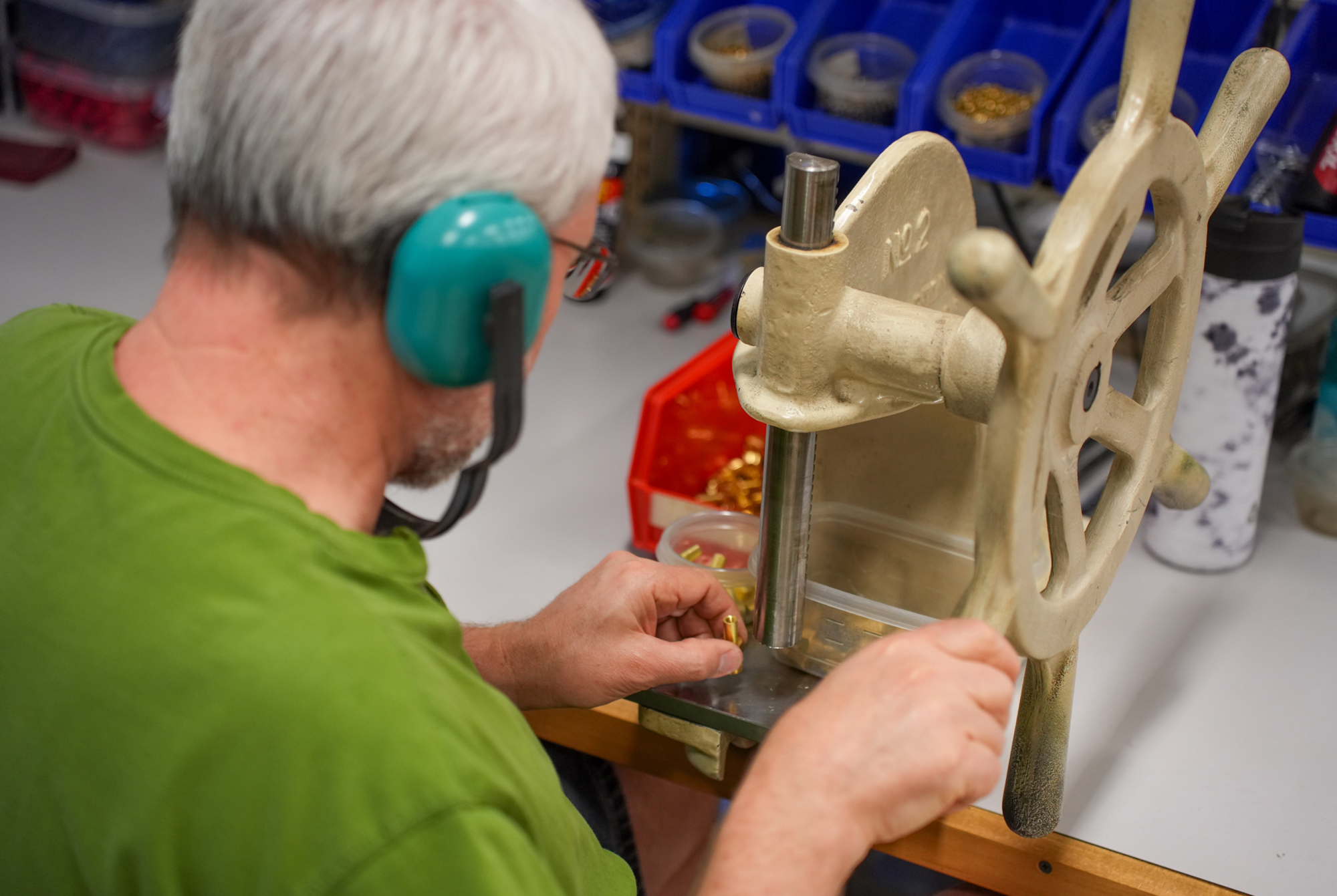 Ralston employee wearing hearing protection working on a calibration tool in a manufacturing environment.