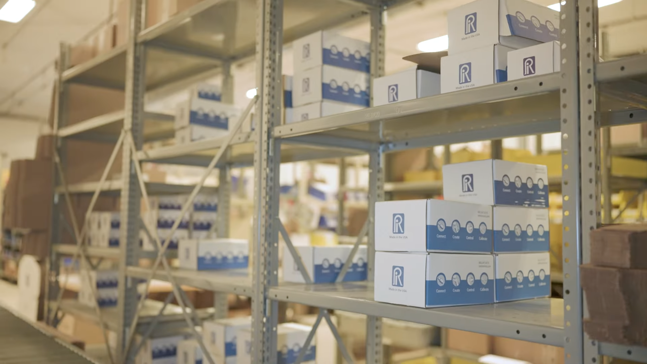 Shelves of packaged Ralston Instruments pressure calibration products, organized for inventory and fulfillment