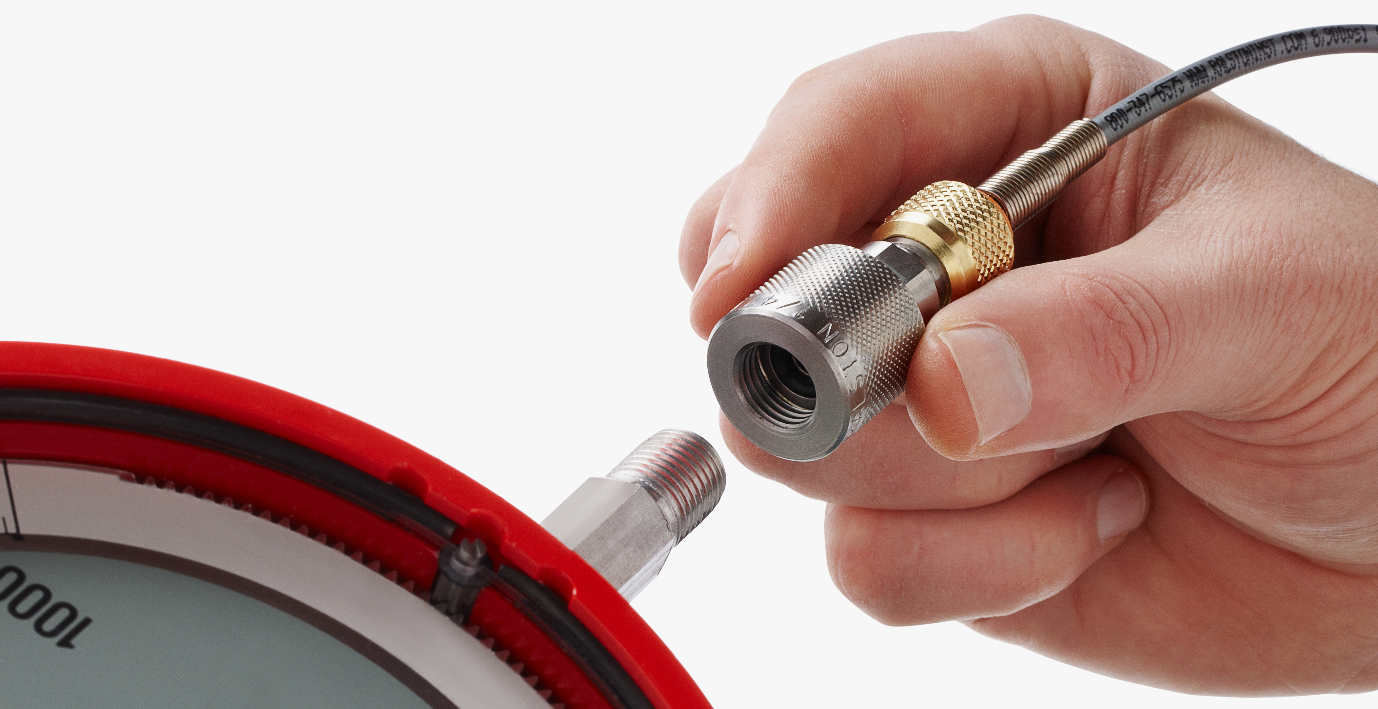 Close-up of a Ralston Quick-test™ fitting being aligned with a threaded pressure gauge connection
