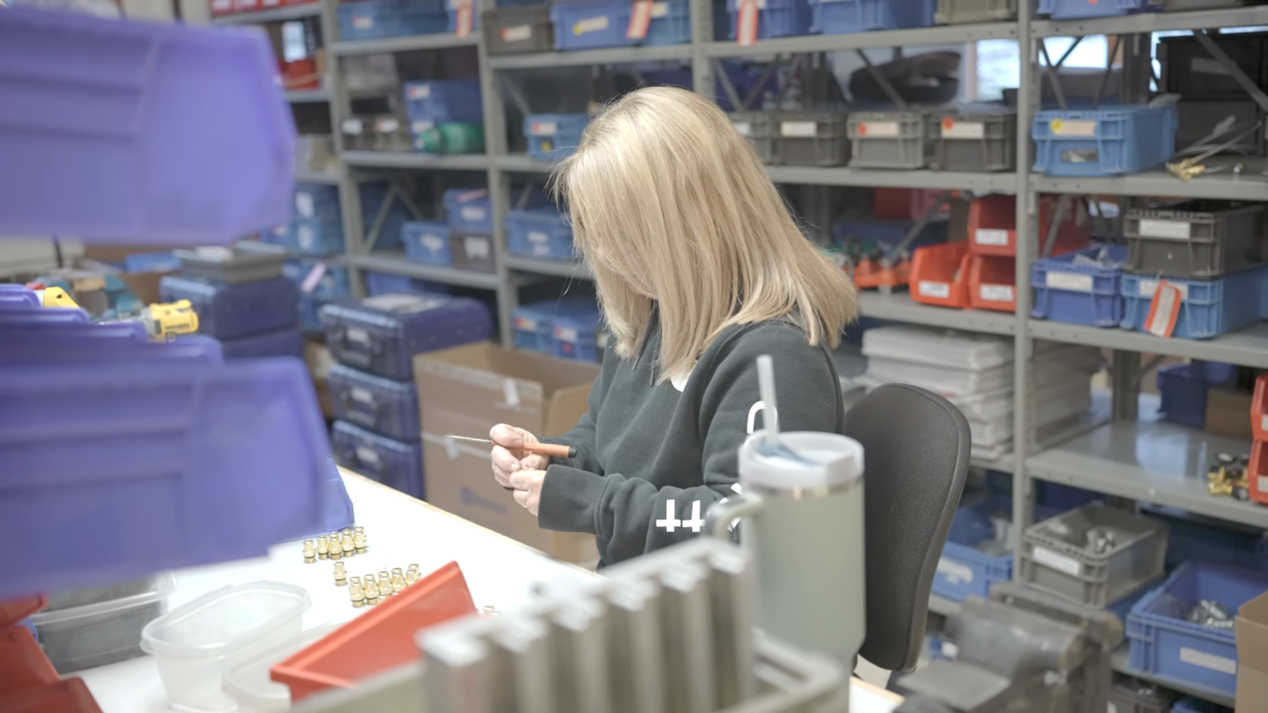 Close-up of a technician assembling small components at a Ralston Instruments workstation
